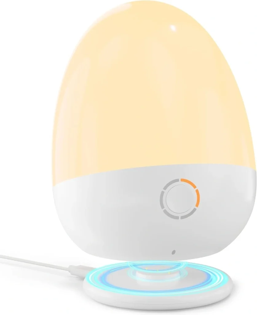 Egg-shaped night light hovering above a wireless charging base with a blue LED ring indicator.